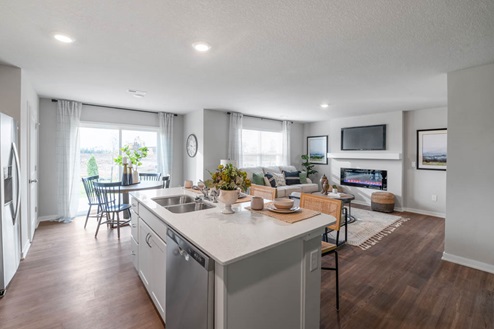 Kitchen island with dishwasher overlooking living room