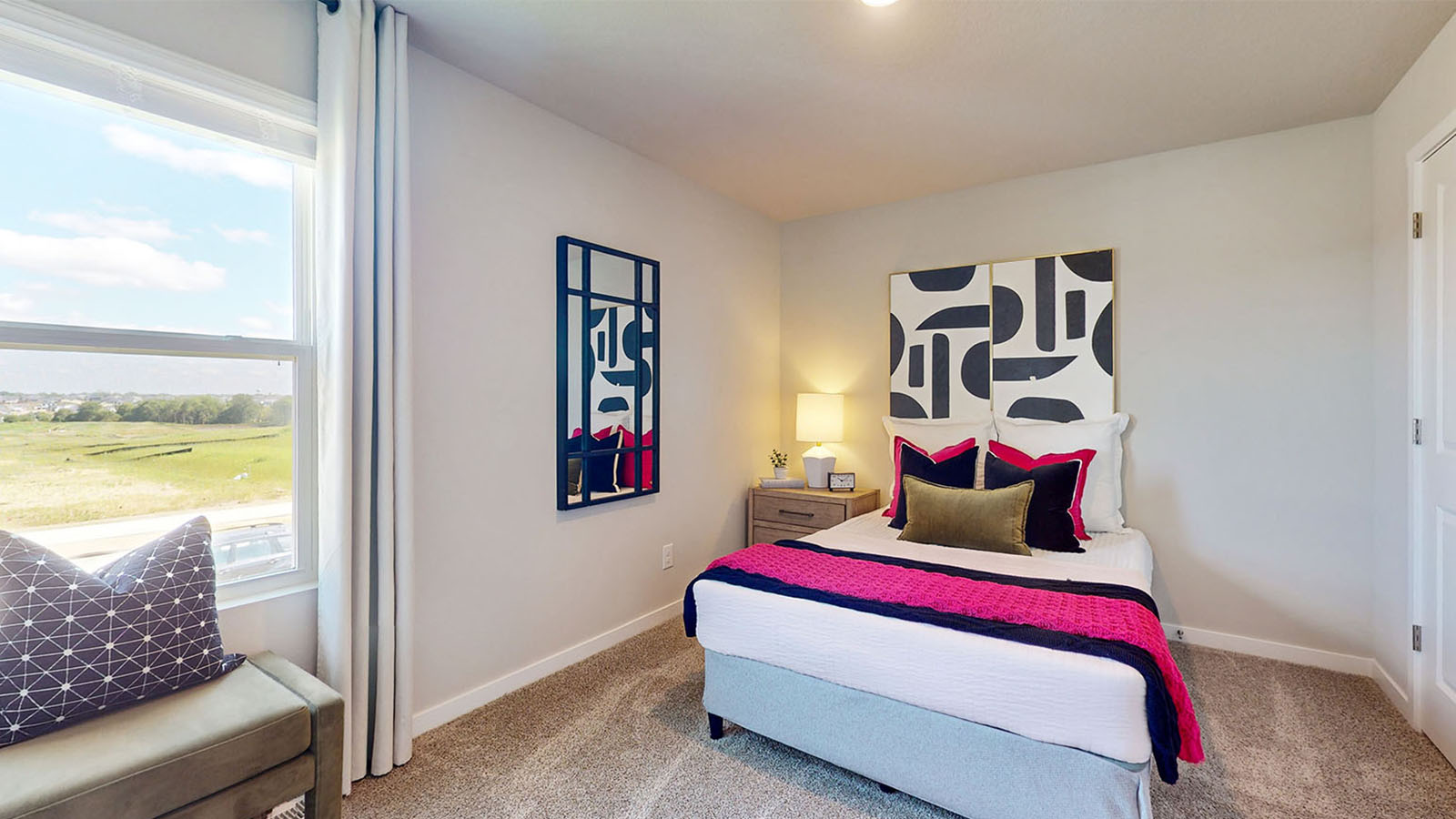 First bedroom with bright window and chair