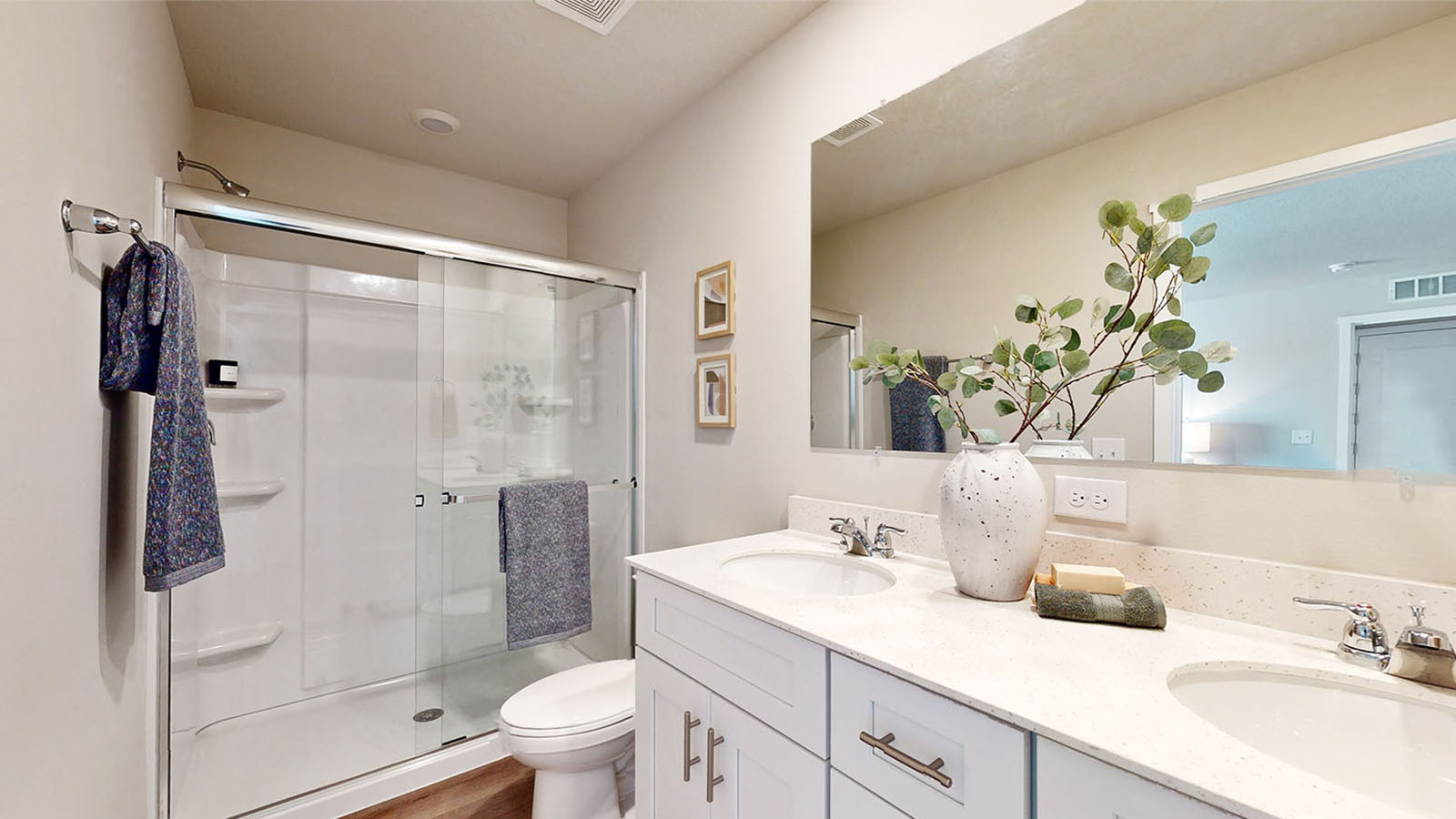 Primary bathroom with large mirror and shower