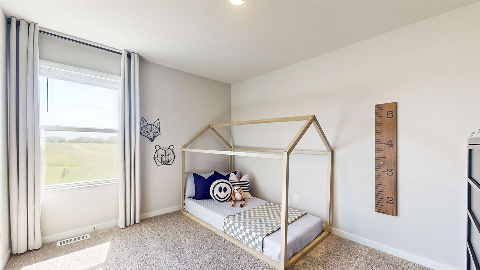 Second bedroom staged as a kids room with window