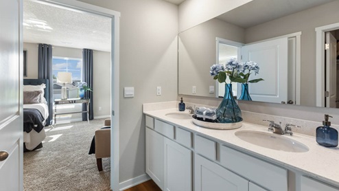 primary bathroom showing the bedroom
