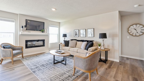 Bright living room with two small windows and overhead lighting