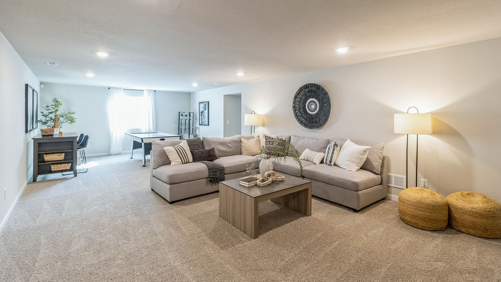 Flex-Game room with neutral finishes and natural light in a D.R. Horton home offering great fun for any lifestyle in fully furnished basement
