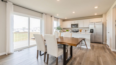 Dining room table with view of modern kitchen