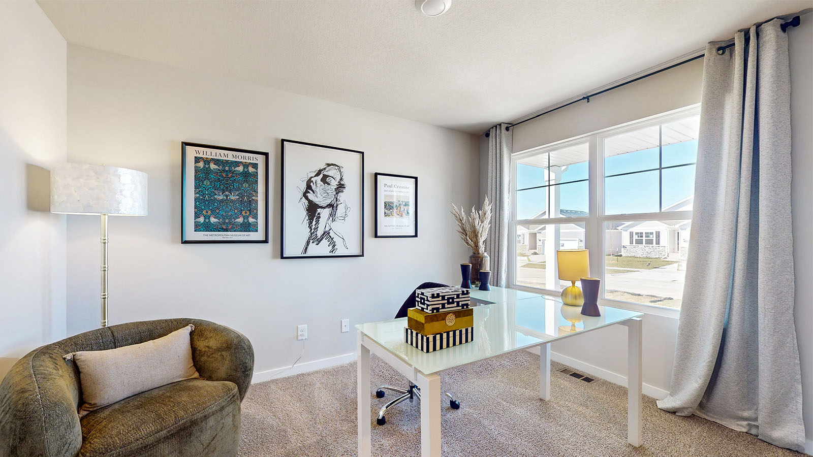 First bedroom staged as a nursery with crib and seating area