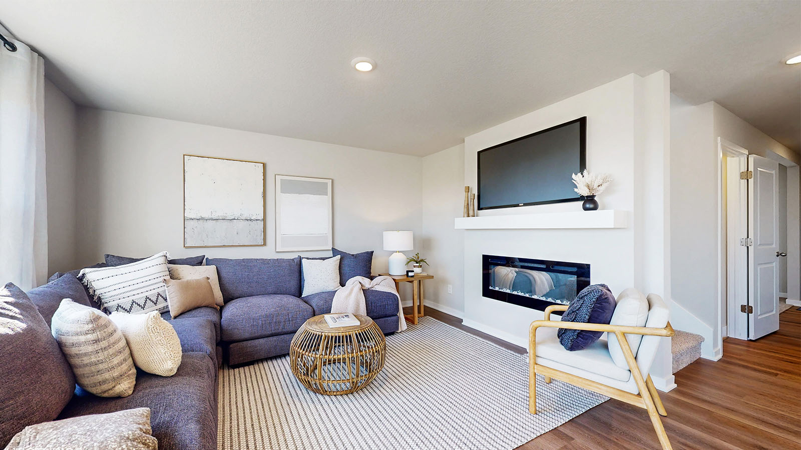 Living room with large grey sectional and mounted tv