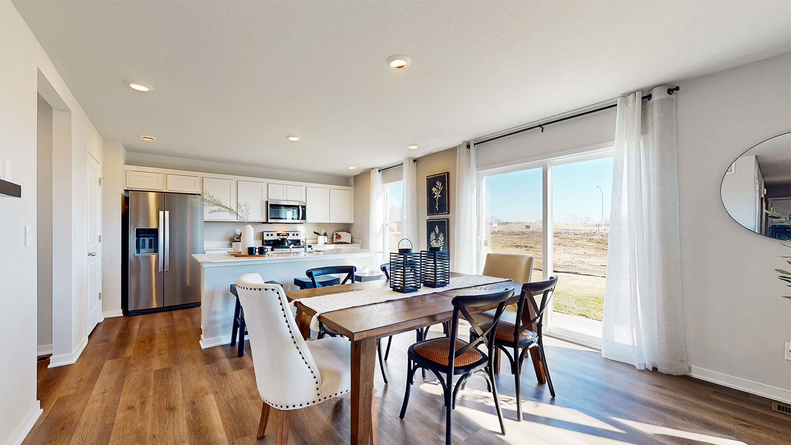 Dining area with wood table and black chairsnext to sliding glass doors