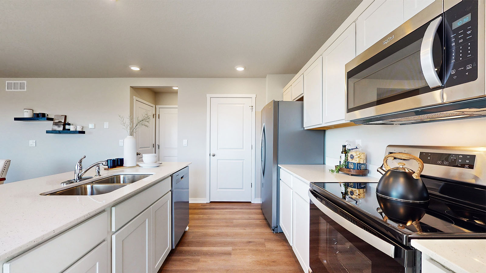 Side view of kitchen with quartz countertops and dual sinks