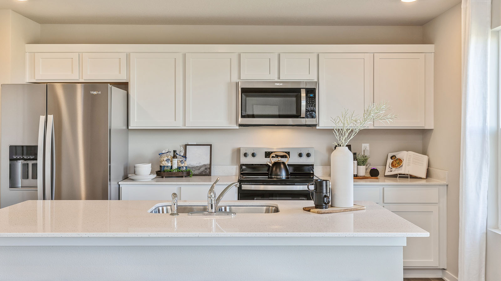 Kitchen featuring white cabinets, stainless steel appliances, and white countertops.