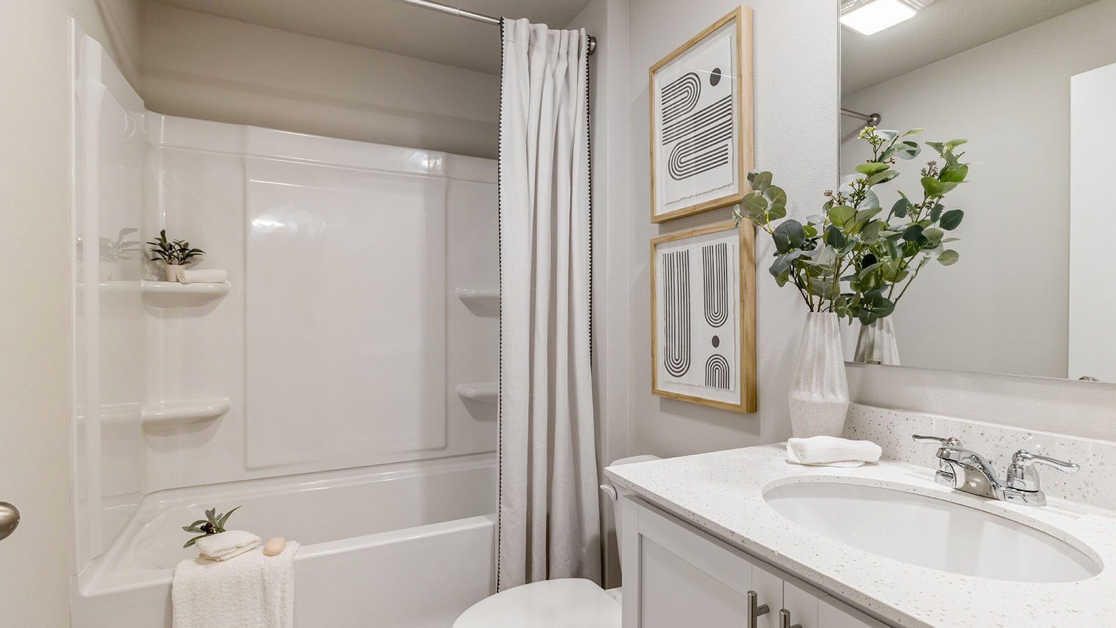 Third bedroom with mirror and bathtub