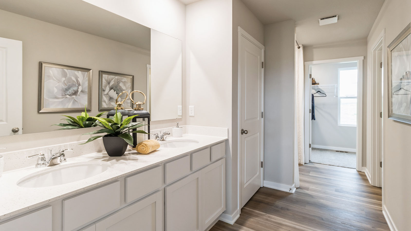 Modern primary bathroom with large mirror and dual sinks