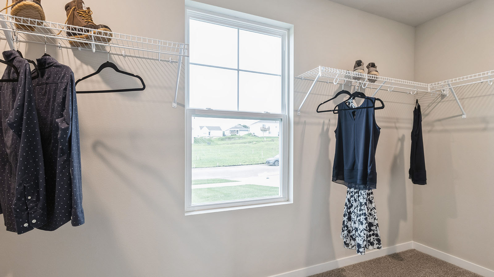 Walk-in closet with small window and white wire shelving