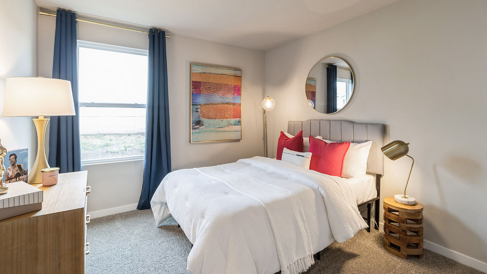 Second bedroom with small window and white bed with grey headboard