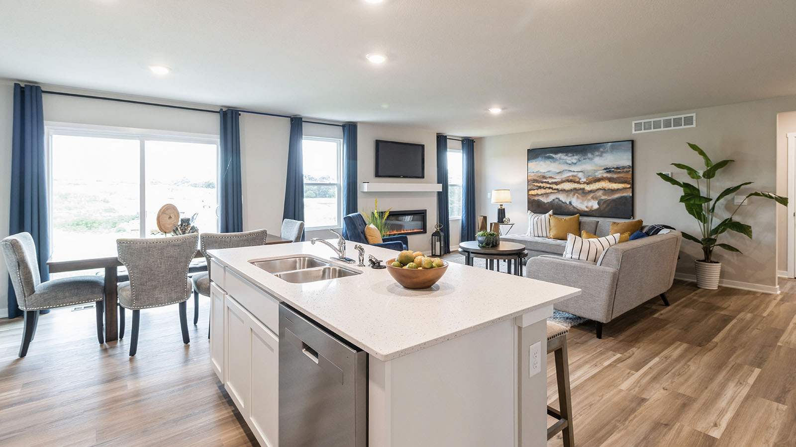 Modern kitchen overlooking dining area and living room