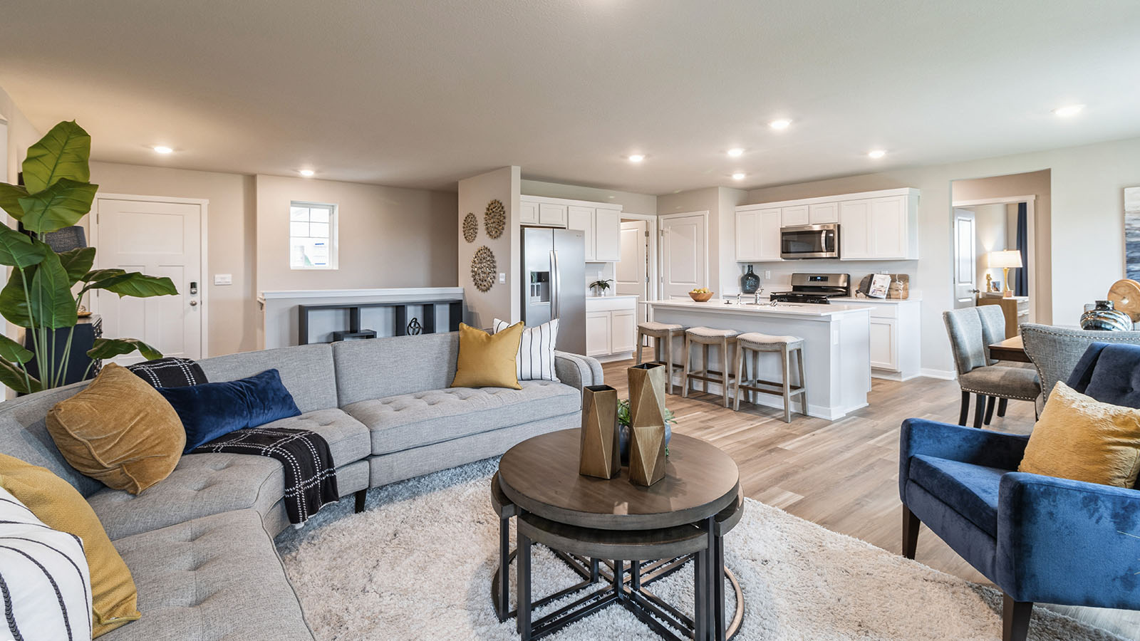 Open living room overlooking spacious white kitchen