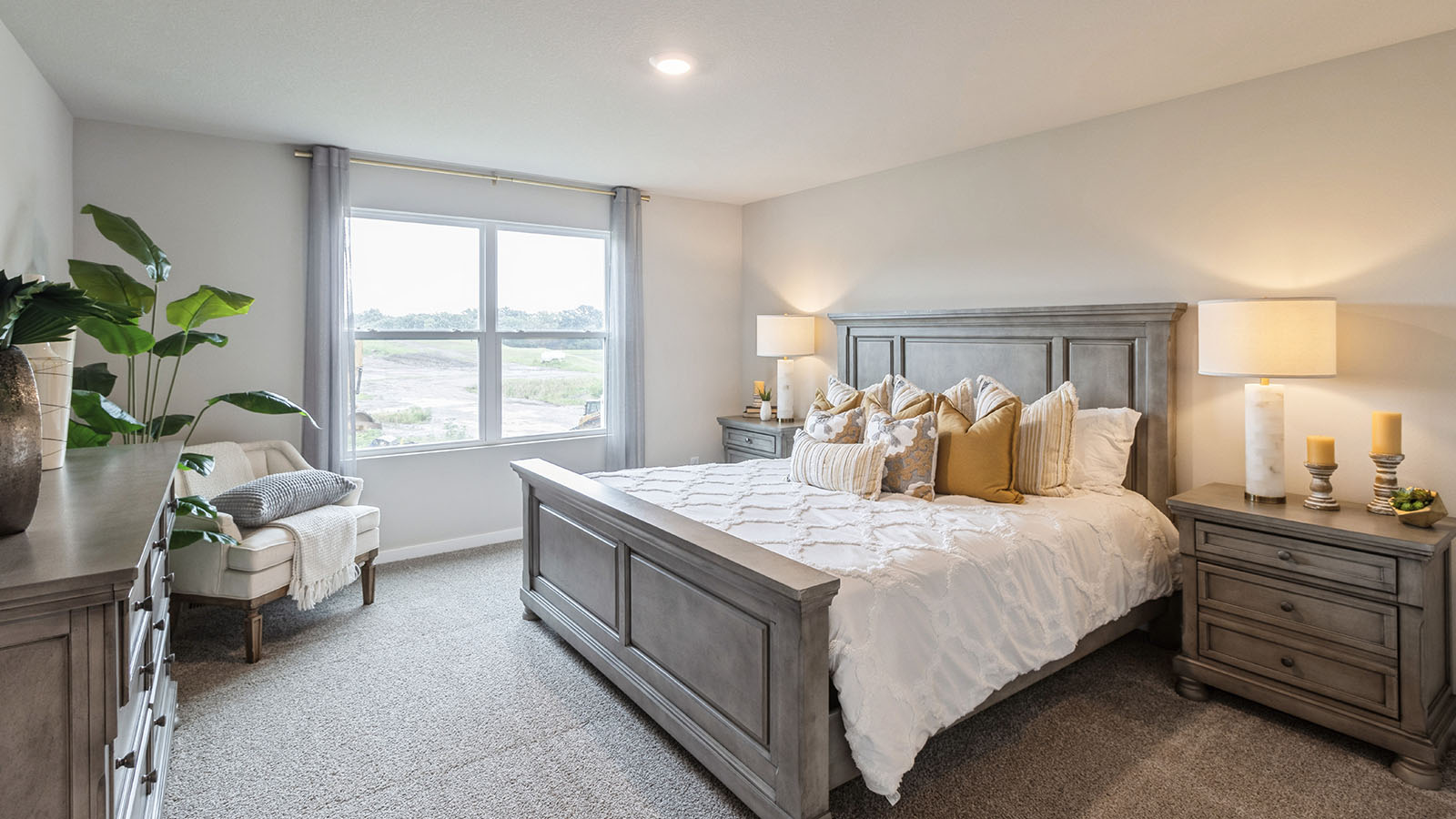 Reagan primary bedroom with large window and white bed with grey nightstands