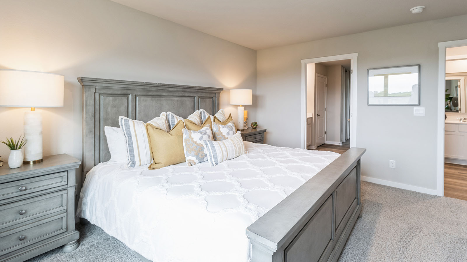 Large primary bedroom with view of walk-in closet