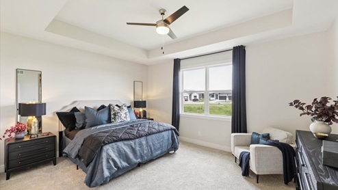 primary bedroom with large window that floods the room with natural light