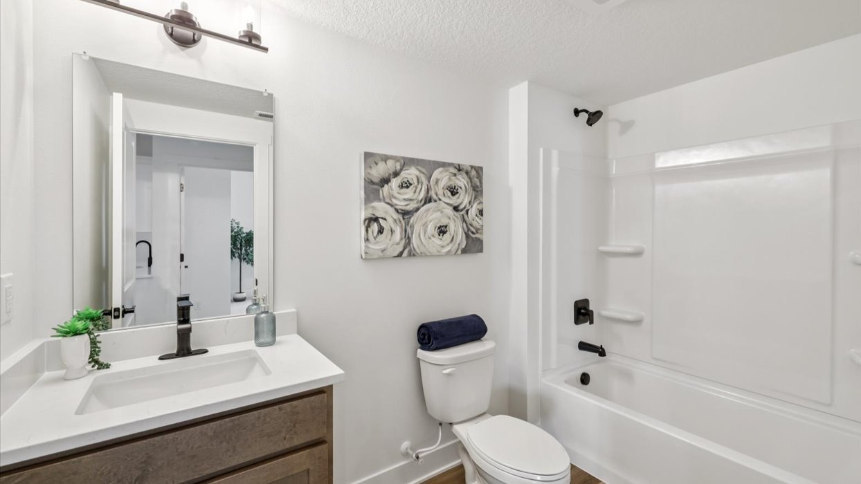 second bathroom with small window and shower with bathtub