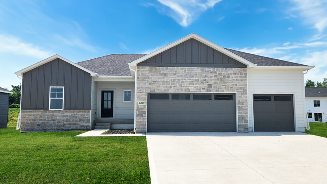 Reagan exterior with stone, 3 car garage and dark grey siding