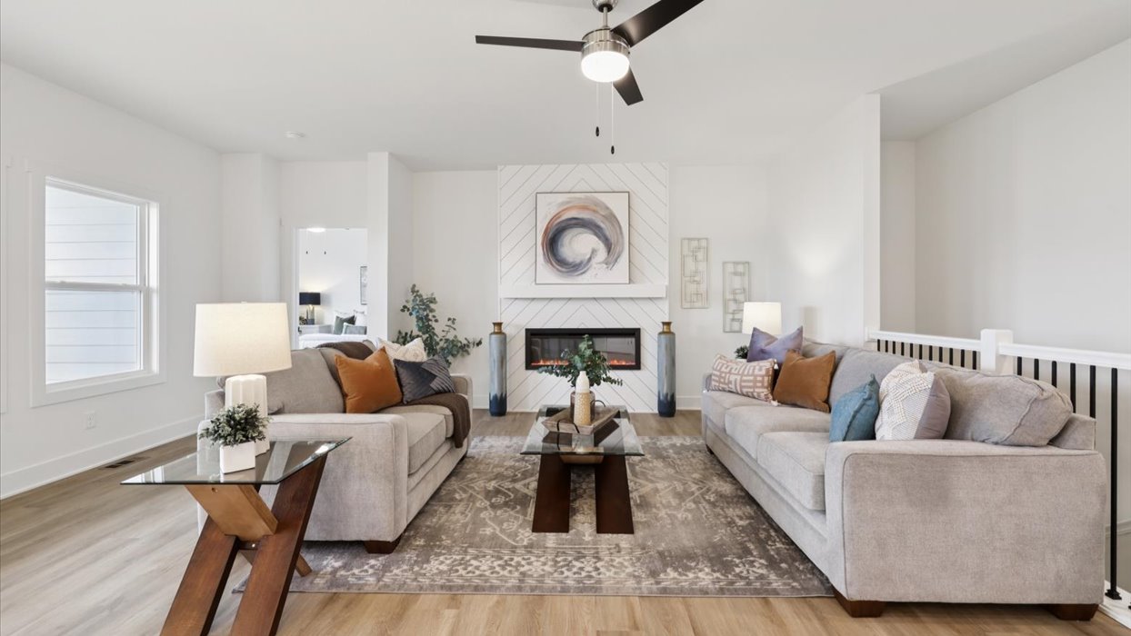 bright and spacious living room with ceiling fan