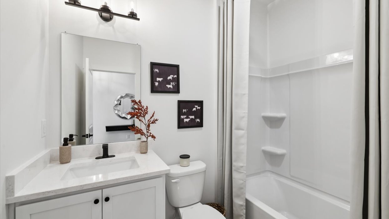 first bathroom with shower and bathtub