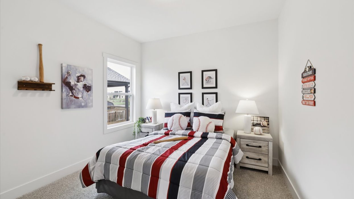 second bedroom with small window and queen bed