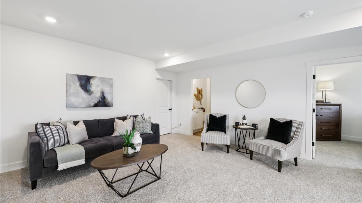 finished basement with two grey couches