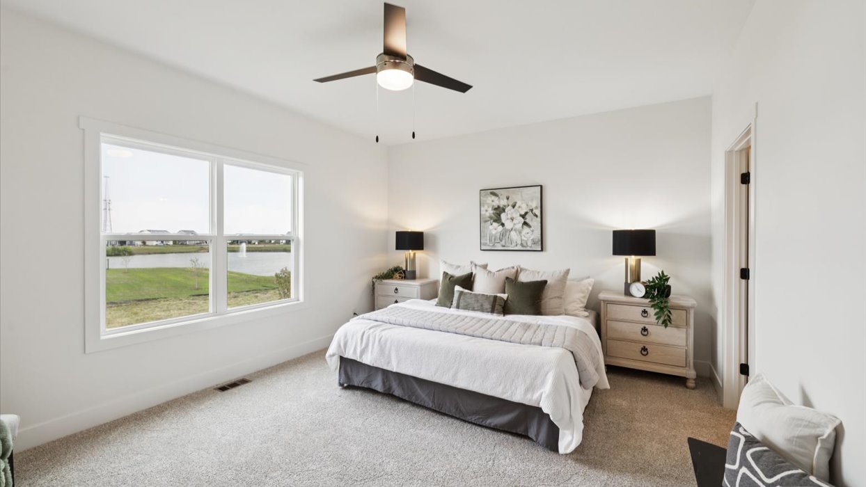 spacious primary bedroom with large window