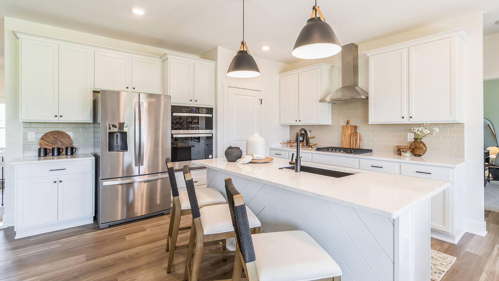 modern and open kitchen with white cabinets and stainless-steel appliances