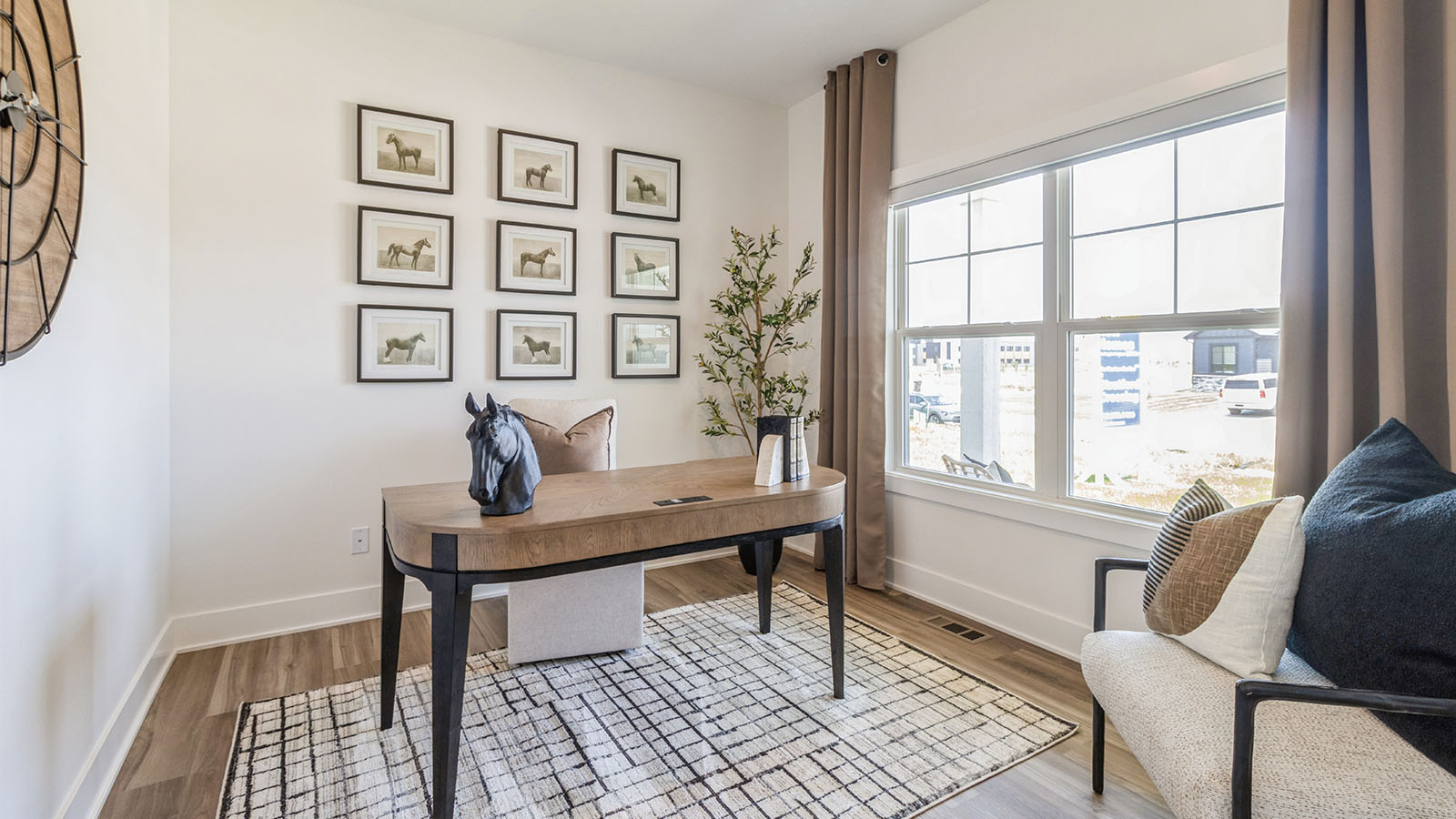 Front office with large window and wood desk with white cozy chair