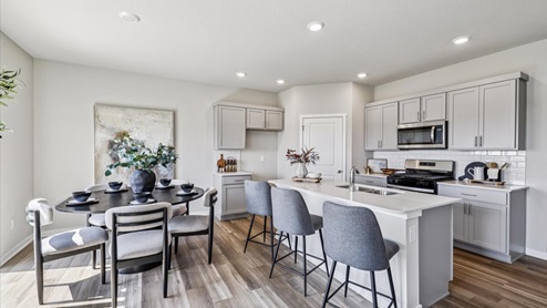 modern dining room and kitchen with black dining table and grey cabinets