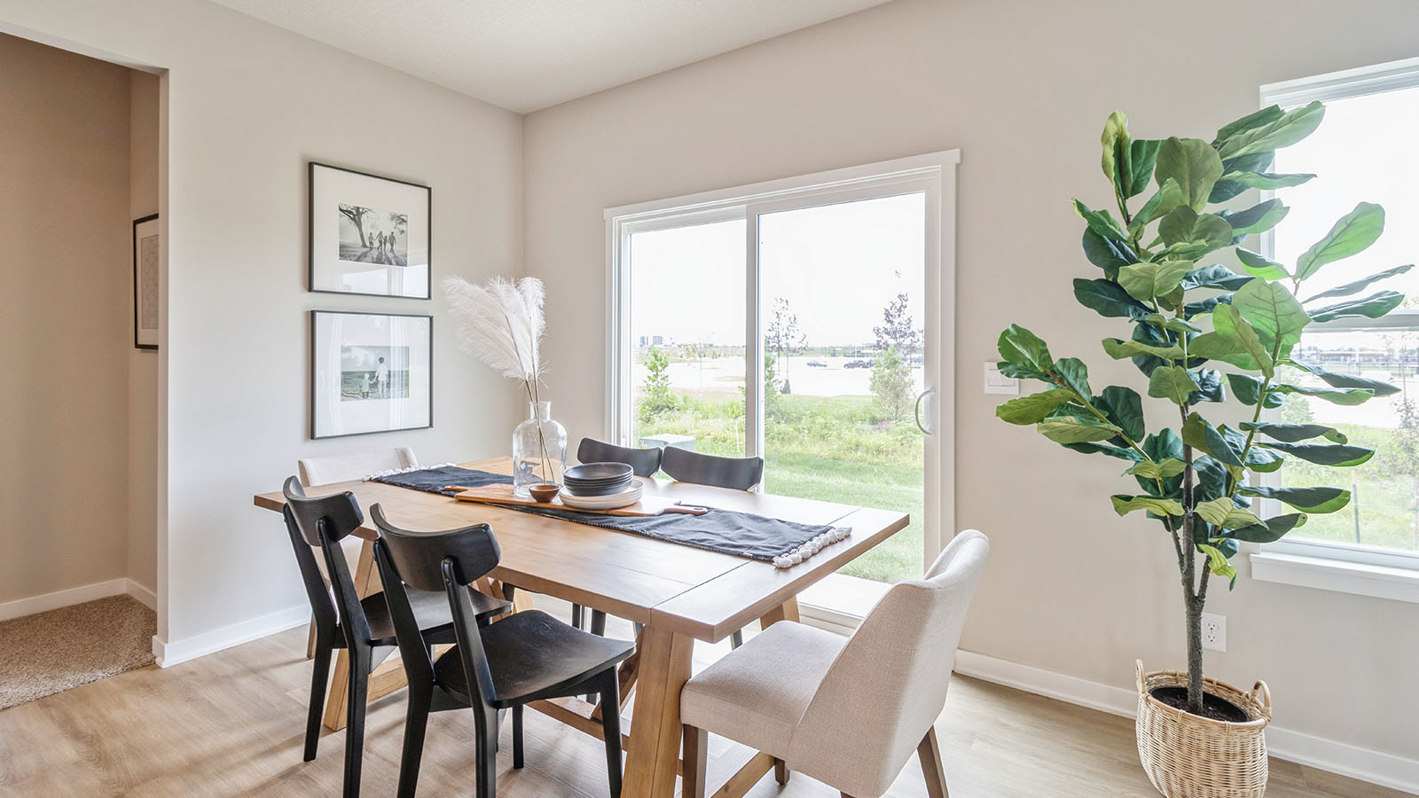 Open concept dining area with simple furnishings and a sliding door.