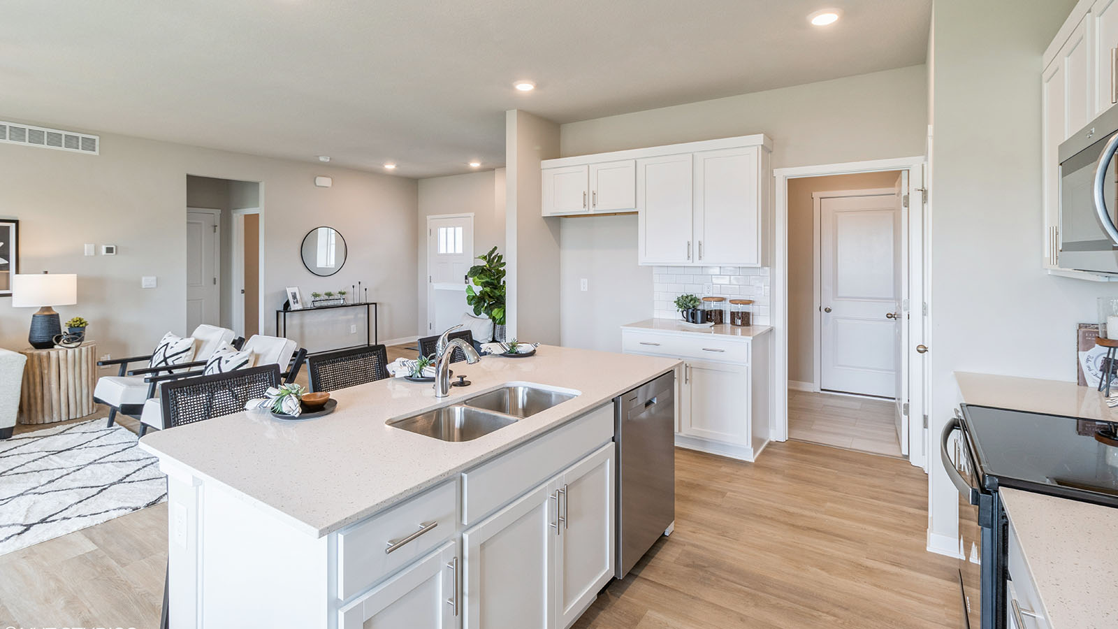 Spacious kitchen with brand new stainless steel appliances connecting to the living area.