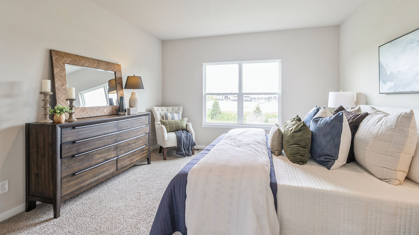 Primary bedroom with neutral walls, carpet, and natural lighting.