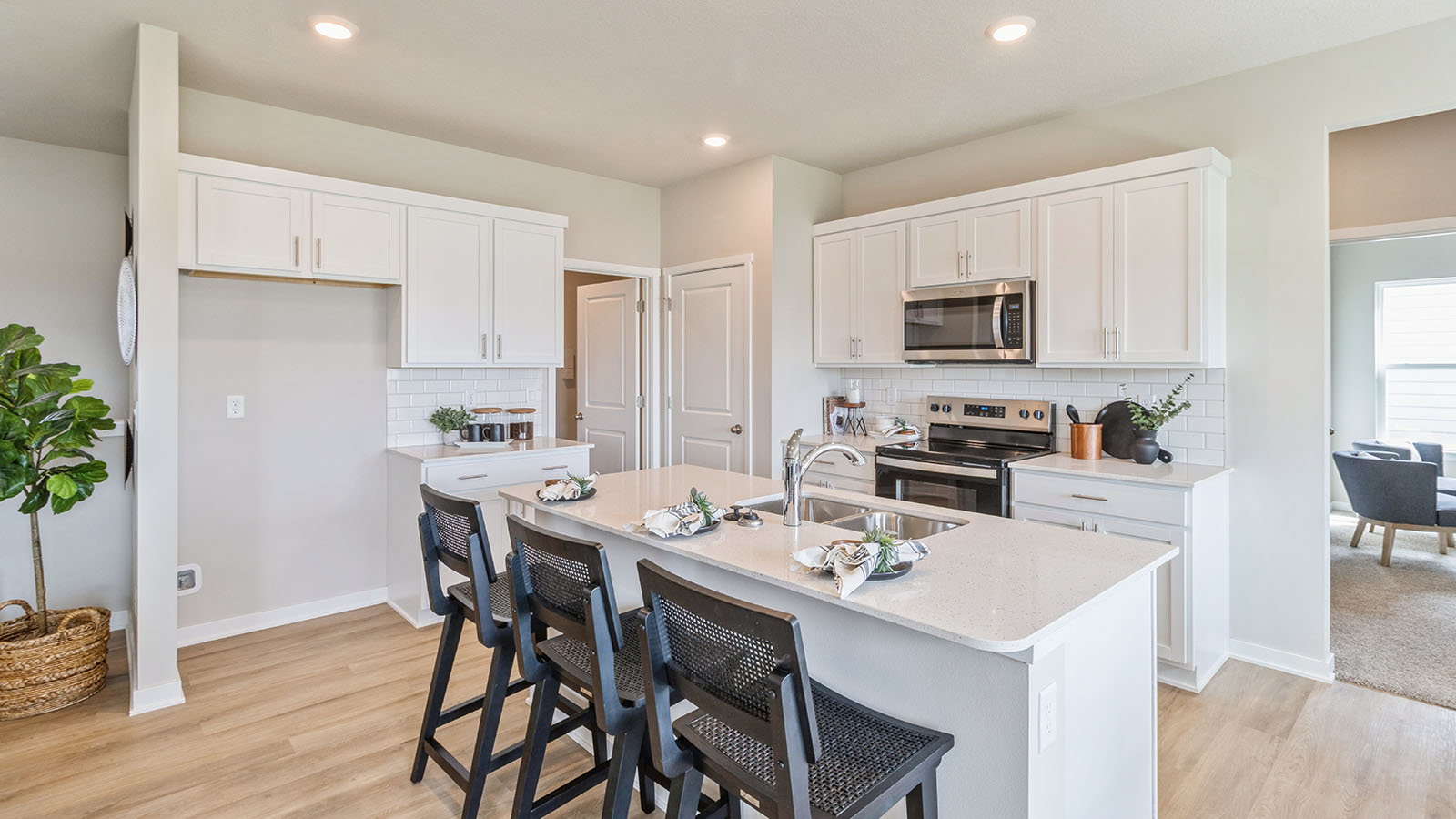 Kitchen featuring white cabinets, new stainless steel appliances, and hard surface countertops.