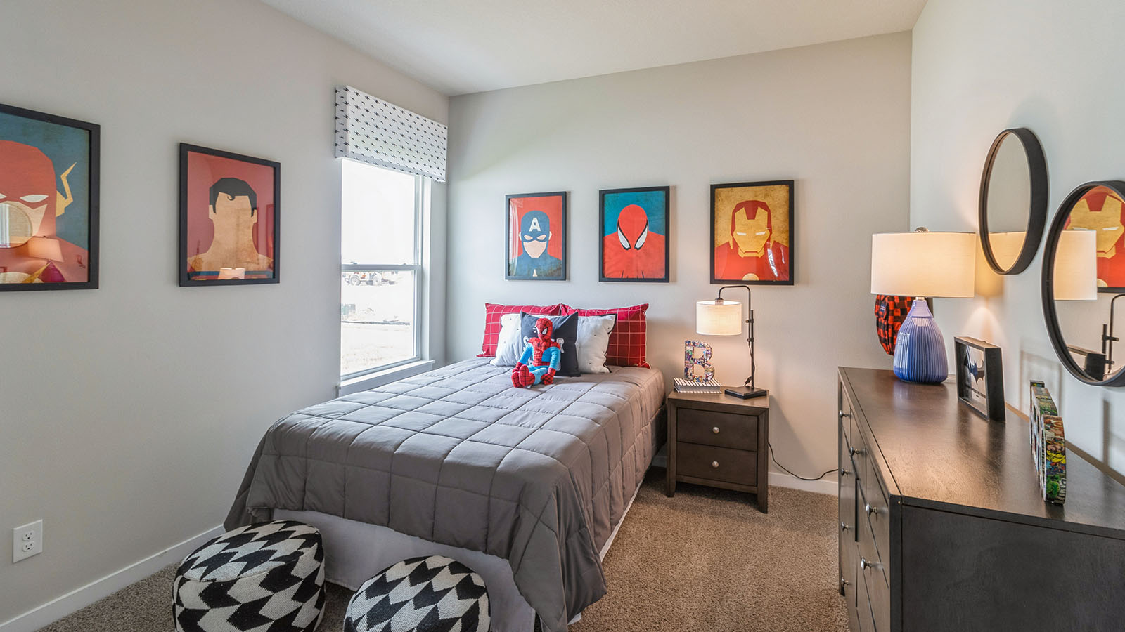 first bedroom with twin grey bed and two wood nightstands and dresser