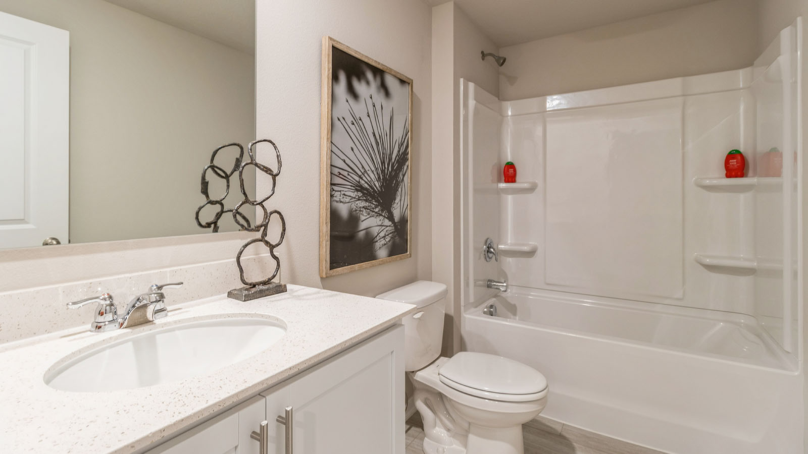 second bathroom with white cabinets and shower with bathtub