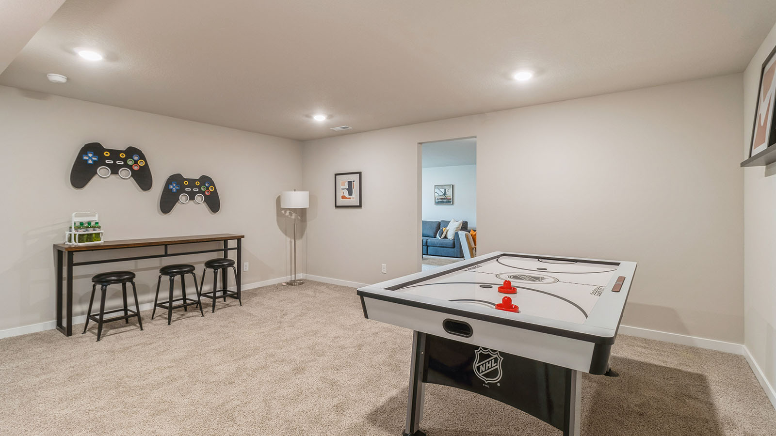 finished basement with air hockey table and table with bar seating