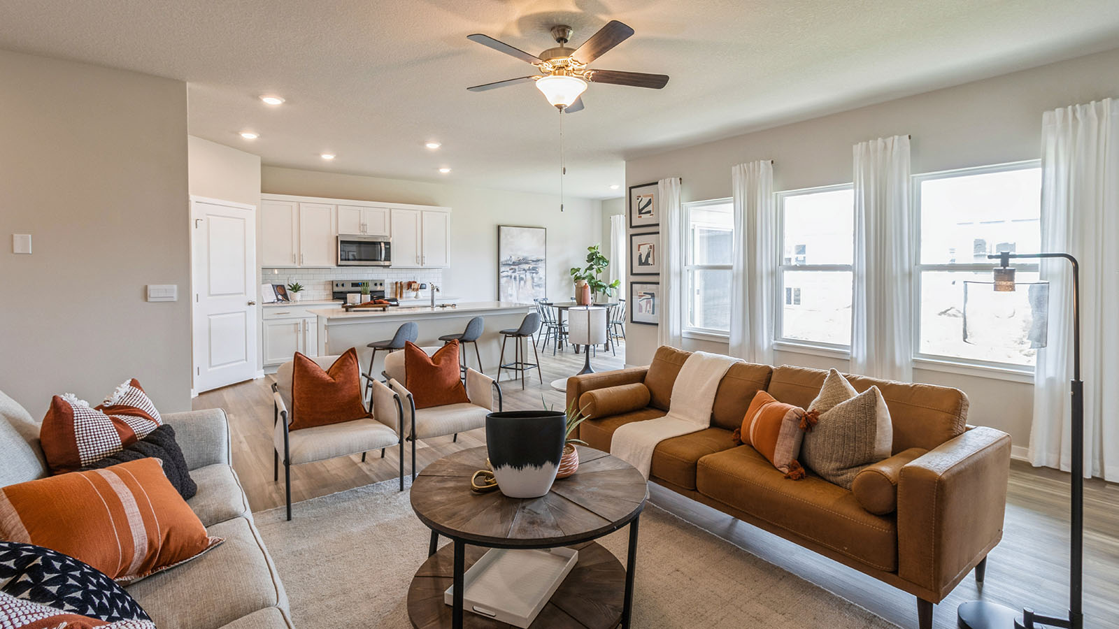 spacious and bright living room overlooking modern kitchen and dining room