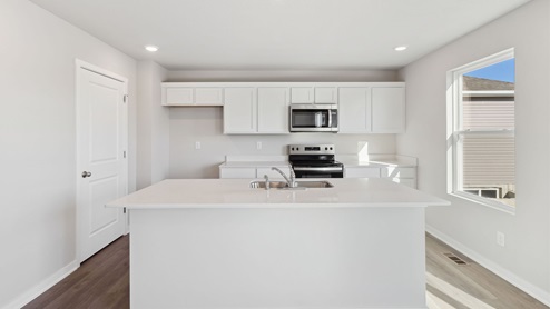 modern kitchen with island and quartz countertops