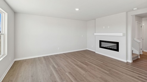 living room with electric fireplace and mantle