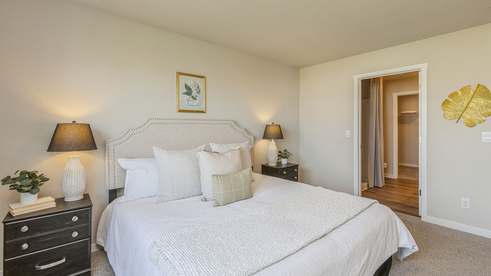 Primary bedroom with view of the primary bathroom