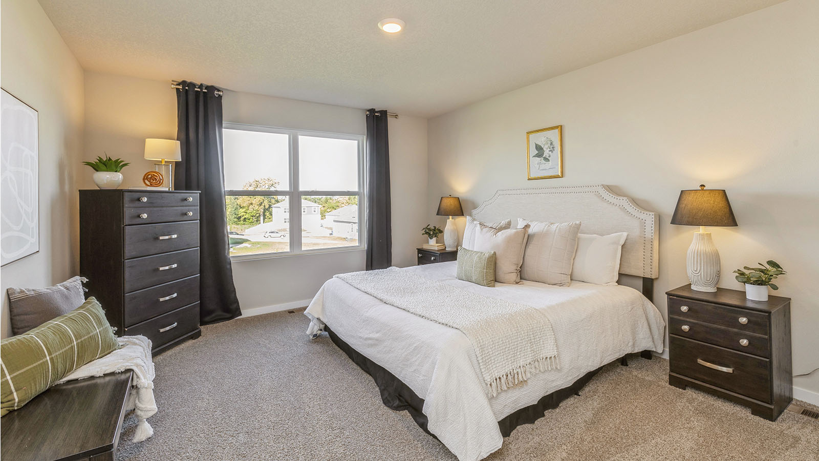 Primary bedroom with a large window and white bed