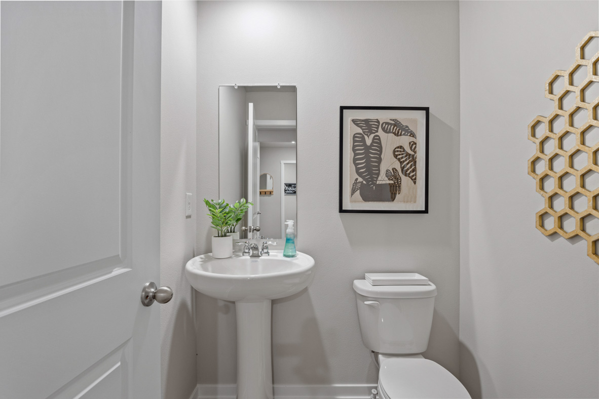 Half bathroom with sink and mirror