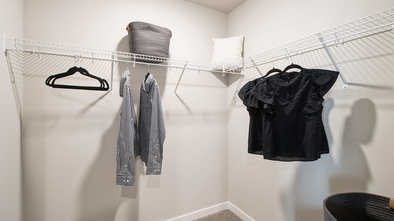 Spacious walk-in closet with white shelving off the primary bathroom