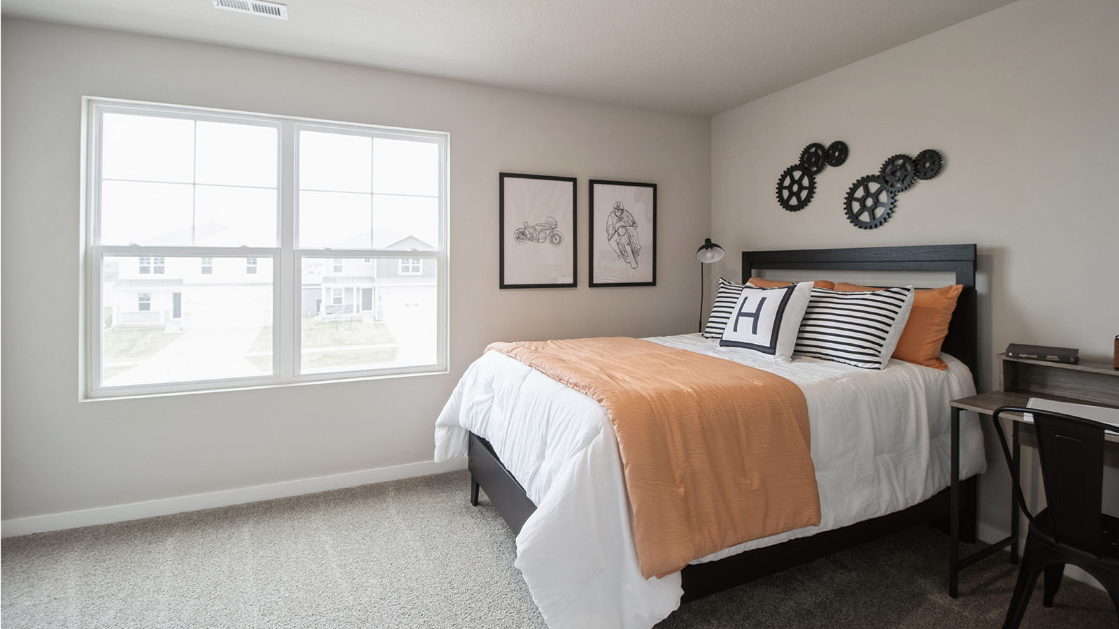 First bedroom with large window and white bed with desk