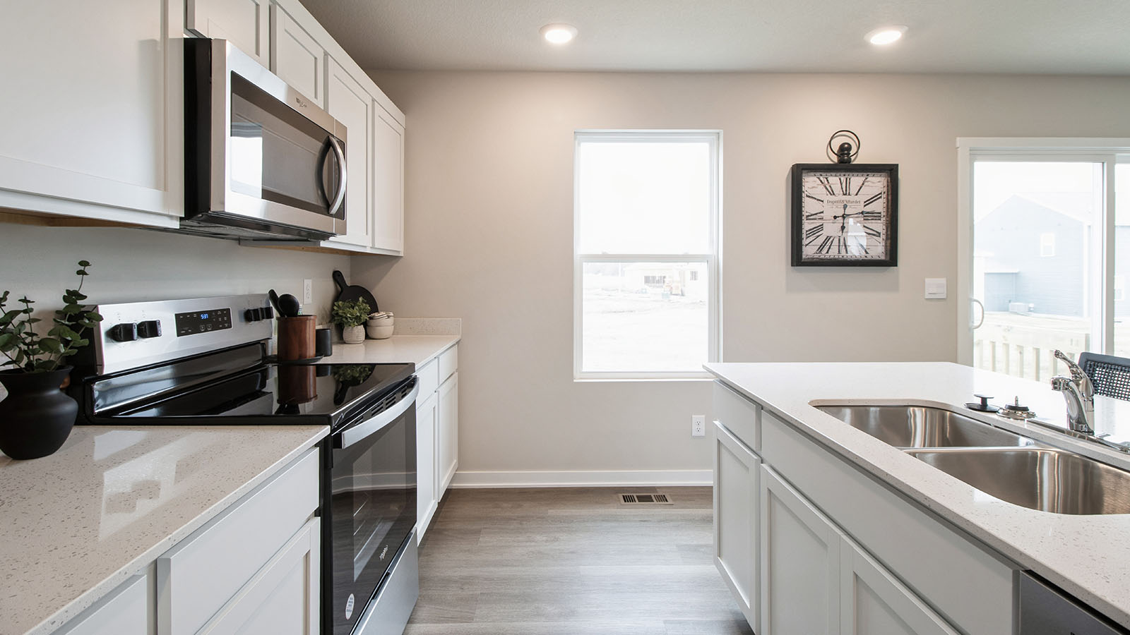 Side view of the kitchen with an island and dual stainless-steel sinks