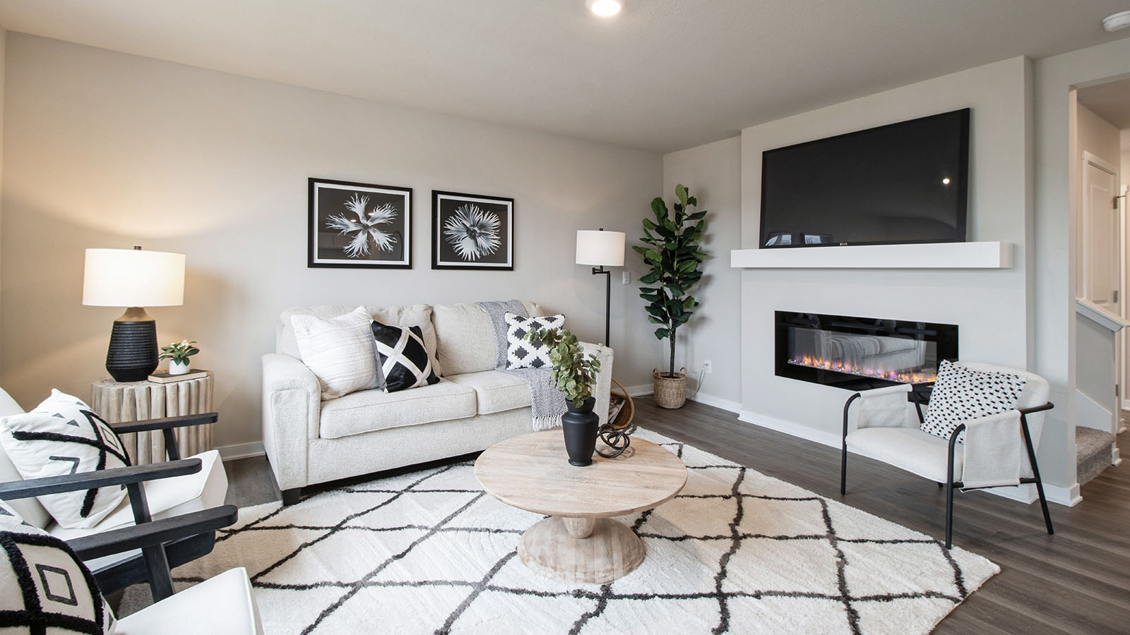 Spacious living room with electric fireplace and mounted tv