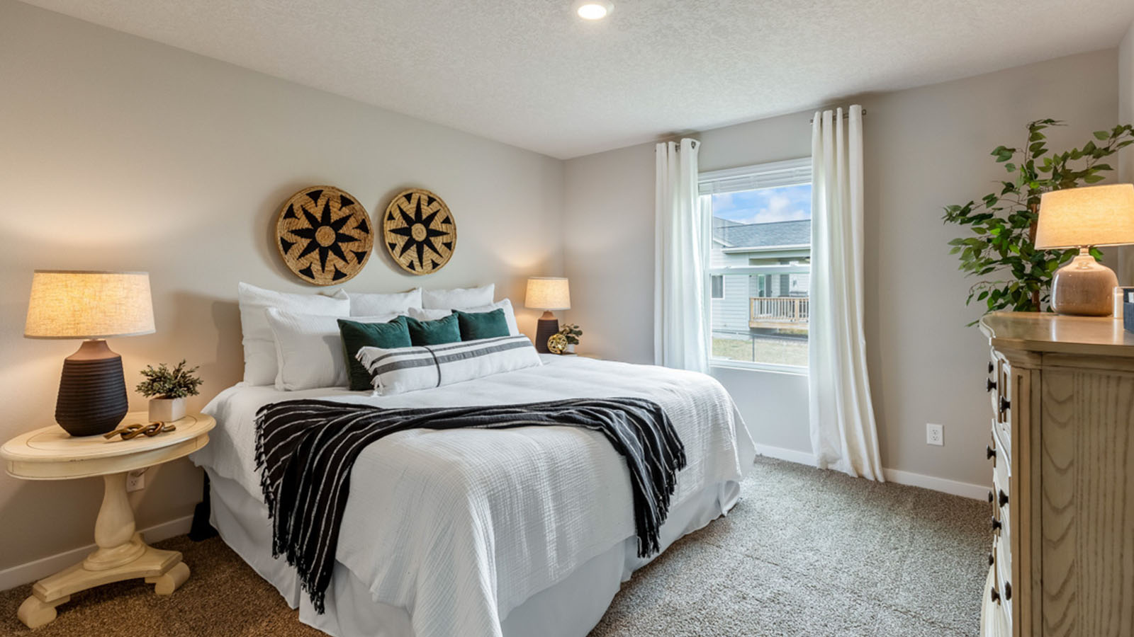 Primary bedroom with large white bed and nightstands